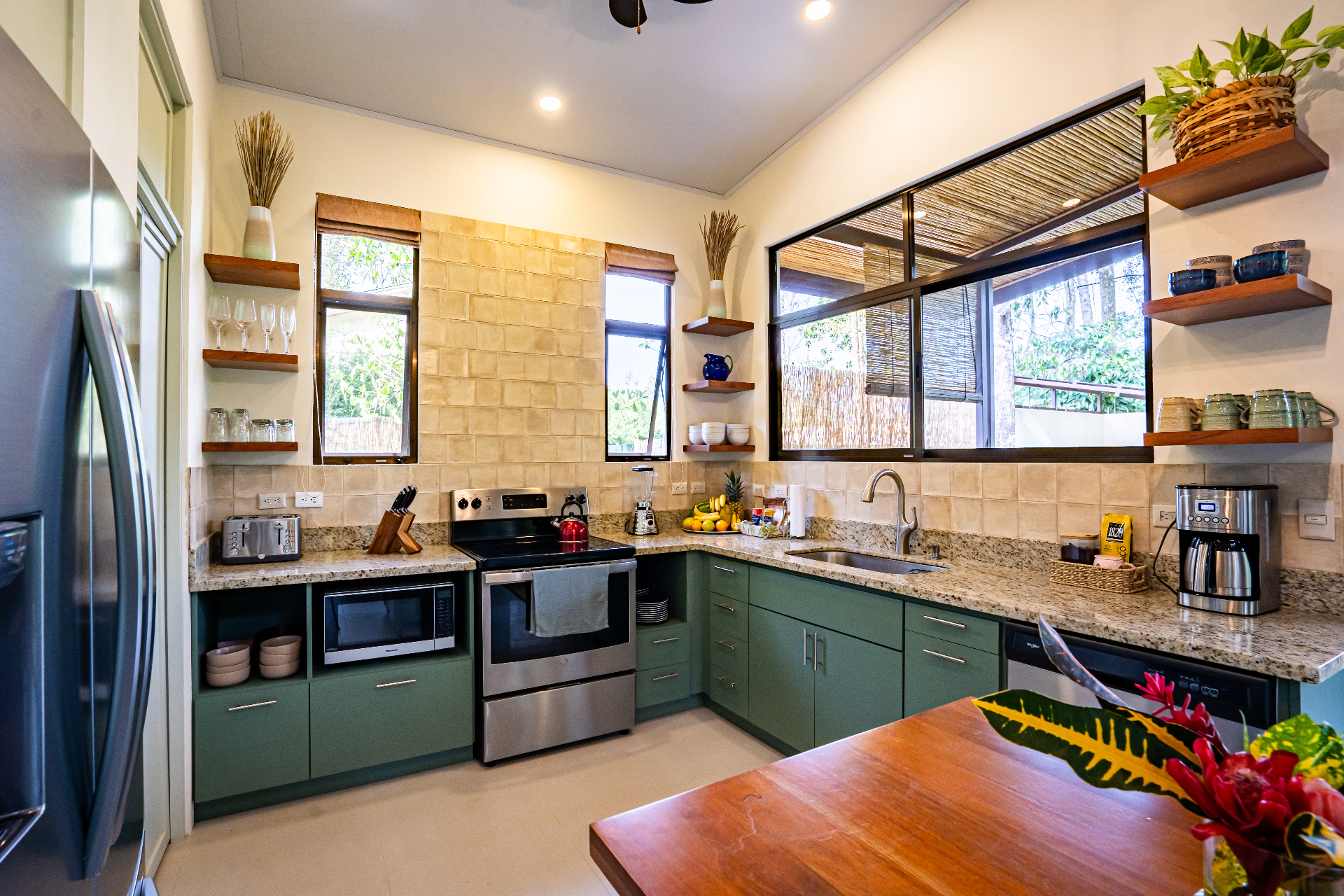 Open kitchen view onto the Uvita rainforest through floor-to-ceiling windows